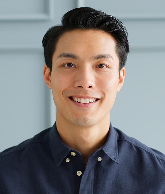 Man standing in front of garage door smiling