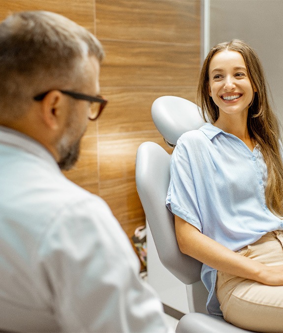 Female patient smiling at dentist at dental appointment